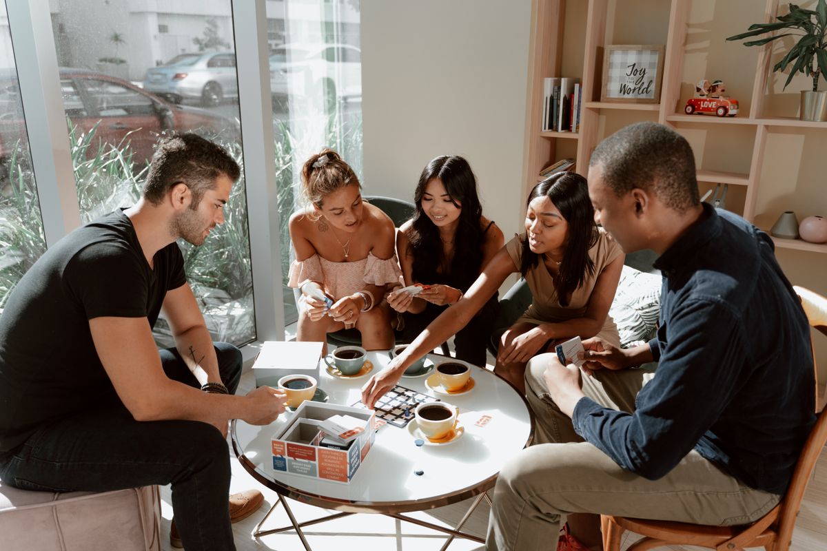 Friends enjoying a board game together in a café