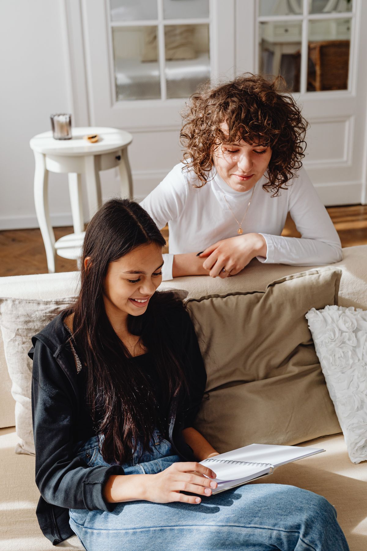 Illustrative photo of two people talking with a notebook