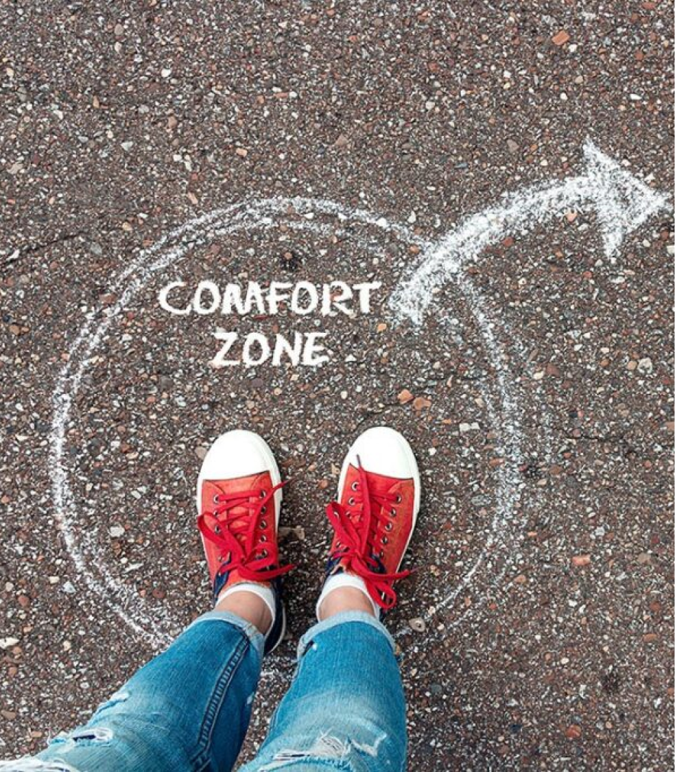 Red sneakers inside a chalk comfort zone circle, with an arrow pointing outward