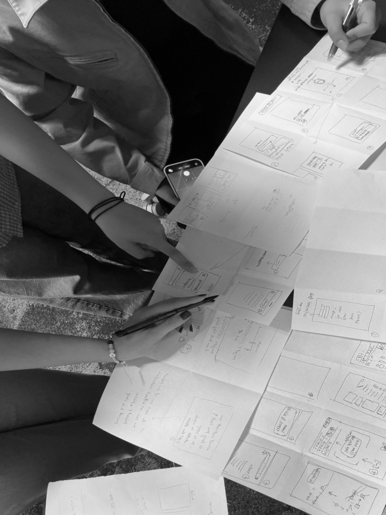 Team reviewing paper sketches