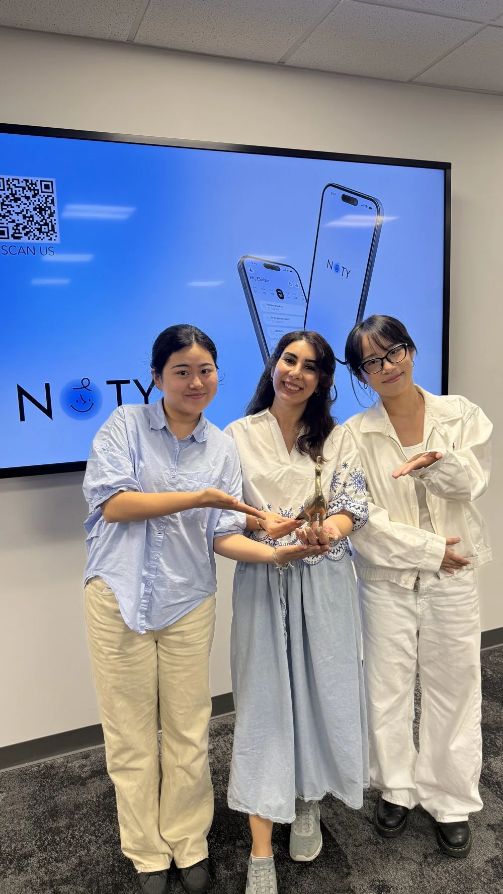 The Noty team holding an award